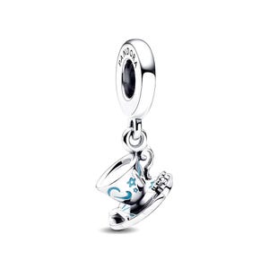 May include: A silver charm in the shape of a teacup and saucer, featuring light blue enamel accents in the form of swirls and small stars. The top loop is engraved with the word PANDORA. The piece is polished to a high shine, reflecting light.