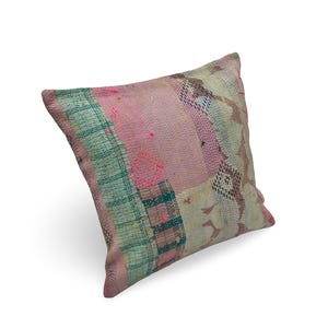 May include: A square throw pillow featuring a patchwork design of various fabric scraps in shades of pink, teal, and cream. The surface is covered in visible running stitch embroidery patterns throughout the entire textile cover.