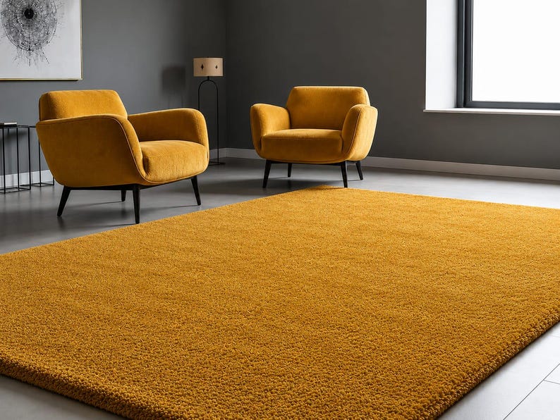 May include: A large, rectangular, mustard yellow area rug with a thick, plush, shaggy texture. The rug covers the floor in the foreground, featuring a dense pile construction that creates a soft, uniform appearance across its entire surface.