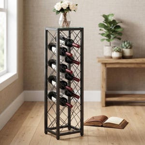 May include: A tall, rectangular black metal wine rack with a cross-hatch lattice design. The rack holds five wine bottles with dark glass and white labels, arranged vertically. A glass top surface holds a clear vase with white flowers.