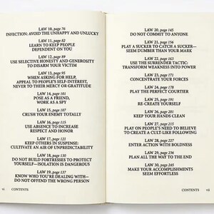 May include: An open book displaying a table of contents with black text on cream-colored pages. The left page lists laws 10 through 19, and the right page lists laws 20 through 30, each with corresponding page numbers and descriptive titles.
