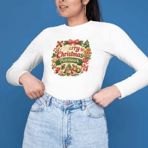 May include: A white long-sleeve shirt featuring a central graphic with the text Merry Christmas Patchwork. The design includes a red plaid bow, a gingerbread man, a Christmas tree, a stocking, and various holiday-themed patchwork patterns.