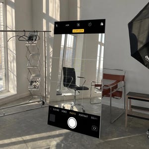 May include: A tall, rectangular floor mirror featuring a printed overlay that mimics a smartphone camera interface. The mirror displays a grid, AE/AF lock icon, and camera mode settings including Slo-Mo, Video, Photo, Portrait, and Square.