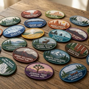 May include: A collection of oval-shaped embroidered patches featuring various United States National Parks, including Grand Canyon, Zion, Yosemite, Glacier, Yellowstone, Olympic, Hawaii Volcanoes, Shenandoah, Grand Teton, Sequoia, and Joshua Tree.