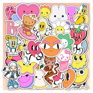 May include: A collection of colorful vinyl stickers featuring various cartoon characters, including a cat, a tiger, a strawberry, a banana, a fried egg, a drink, and several heart, star, and flower shapes with expressive faces and bold outlines.