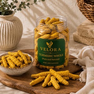 May include: A clear plastic jar filled with whole turmeric roots, featuring a dark green label with the text VELORA TURMERIC WHOLE (Pure and Natural). Beside the jar is a small ceramic bowl and loose turmeric roots on a wooden board.