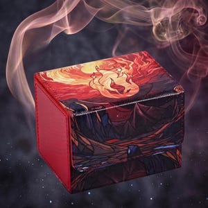 May include: A rectangular deck box with a red side panel and a top flap featuring a vibrant illustration of a stylized sun and flames over a dark, jagged landscape. The surface has a textured finish, and the design incorporates shades of orange, yellow, deep red, and black.