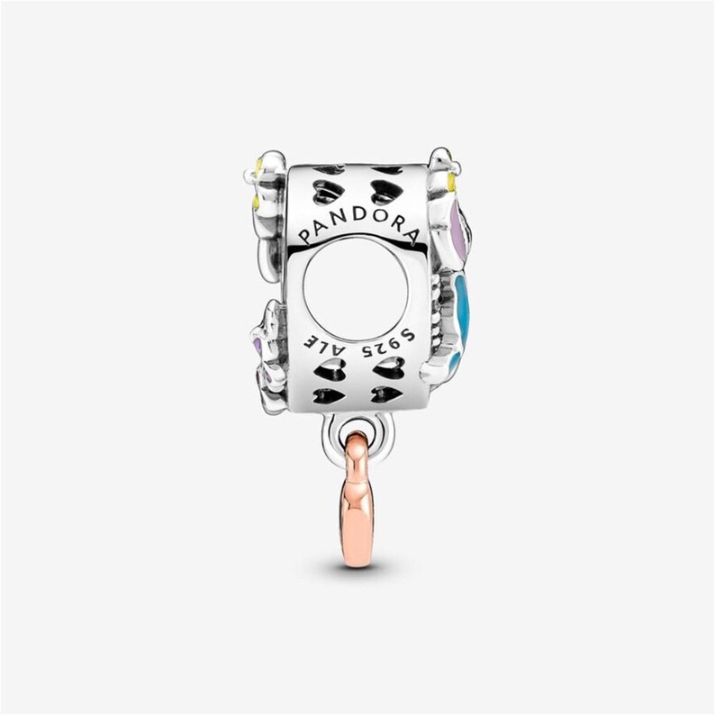 May include: A sterling silver charm bead featuring the engraved text PANDORA and ALE S925. The cylindrical charm is decorated with a pattern of small black hearts and includes a dangling rose-gold colored metal element at the bottom.