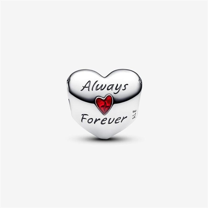 May include: A heart-shaped silver charm bead featuring the engraved text Always Forever in black script. A small, vibrant red heart icon is positioned between the two words. The side of the charm is marked with the letters ALE.