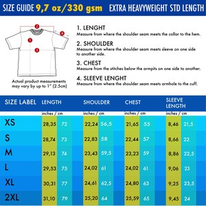 May include: A size guide chart for a t-shirt featuring a line drawing with numbered measurement points for length, shoulder, chest, and sleeve length. The table lists dimensions in inches and centimeters for sizes XS through 2XL, noting 9.7 oz/330 gsm.