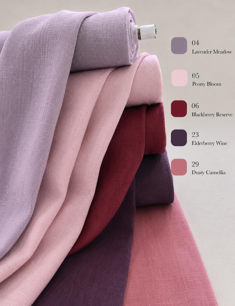 May include: A stack of five fabric bolts in shades of lavender, light pink, deep red, dark purple, and dusty rose. The text labels include 04 Lavender Meadow, 05 Peony Bloom, 06 Blackberry Reserve, 23 Elderberry Wine, and 29 Dusty Camellia.