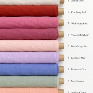 Op de afbeelding: Negen rollen stof verticaal gestapeld, elk op een kartonnen koker. De kleuren zijn Alpine Snow, Cranberry Red, Wild Peony Pink, Vintage Roseberry, Blush Magnolia, Lavender Mist, Periwinkle Sky, Sage Garden en Apricot Cream.