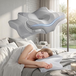 May include: A light gray ergonomic pillow with a contoured shape, a central depression, and a textured surface. The pillow features a small white label with the text Kaisysland. It is designed with multiple curves to support the head and neck.