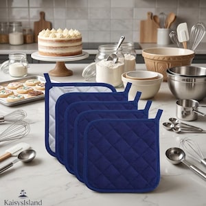 May include: A set of four square, navy blue quilted pot holders featuring a diamond-stitched pattern and a white interior lining. Each pot holder has a small white fabric tag with the text KaisysIsland printed in black.