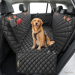 May include: A black quilted car seat cover for pets installed in the back seat of a vehicle. The cover features a diamond-stitched pattern, tan leather-like accents, a storage pocket containing a grey bottle and red disc, and a golden retriever.