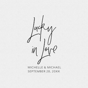 May include: A wedding invitation with the text "Lucky in Love" in a handwritten font. The names Michelle & Michael and the date September 28, 20XX are printed below the text.