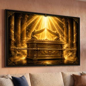 May include: A rectangular wall art print featuring a golden Ark of the Covenant with two kneeling winged figures on top. The scene is set between ornate pillars with bright light rays shining down from above, creating a glowing, metallic aesthetic.