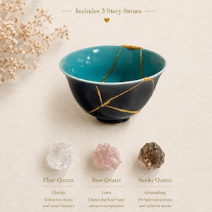 May include: A dark charcoal bowl with a vibrant turquoise interior, featuring gold-colored kintsugi-style cracks. Below are three raw stones labeled Clear Quartz, Rose Quartz, and Smoky Quartz, with text describing their properties.