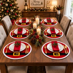 May include: Six round red placemats featuring a black belt design with a yellow buckle and a white crocheted border. Each placemat holds a white plate, a folded red napkin topped with holly berries, a gold fork, a gold knife, and a gold spoon.