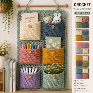 May include: A sage green crochet wall organiser featuring six pockets in cream, blue, pink, yellow, purple, and green. Each pocket has a wooden button. The organiser holds a notebook, plush toys, markers, and flowers. A colour chart is on the right.