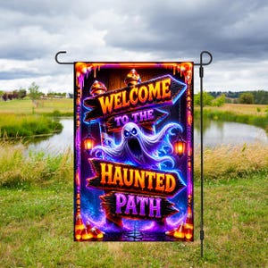 May include: A rectangular garden flag featuring a spooky ghost illustration and the text "WELCOME TO THE HAUNTED PATH" on wooden-style signs. The design includes glowing lanterns, purple and orange lighting, and candy corn accents on a dark background.