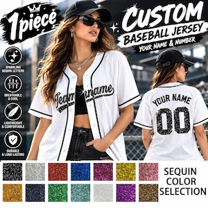 May include: A white baseball jersey with black trim, featuring black sequin lettering on the front and back. The back displays the text YOUR NAME and the number 00 in large black sequins. A colour chart shows various sequin colour options.