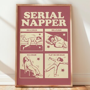 May include: A rectangular wall art print in a wooden frame featuring a deep red background and cream-colored text reading SERIAL NAPPER. Four illustrations depict a person sleeping on a couch, on a floor, in a chair, and flat on their back.