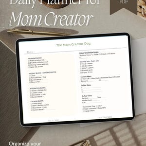 May include: A digital daily planner for a mom creator displayed on a tablet screen. The template includes sections for a morning block, midday naptime hustle, afternoon block, evening block, content plan, and a self-care and business tracker.