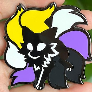 May include: A black metal enamel pin featuring a stylized fox with multiple tails. The fox has a black body with white eyes and chest markings. The tails are colored in segments of bright yellow, white, purple, and black, creating a vibrant design.