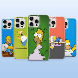 May include: Five smartphone cases featuring various illustrations of Homer Simpson. The designs include Homer hiding in a green hedge, Homer upside down at a bar, and other expressive poses of the character against blue, green, and orange backgrounds.