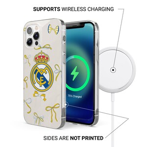 May include: A clear phone case featuring the Real Madrid logo and yellow bow illustrations. The case is shown on a smartphone displaying a green wireless charging icon and 75% battery. Text reads SUPPORTS WIRELESS CHARGING and SIDES ARE NOT PRINTED.