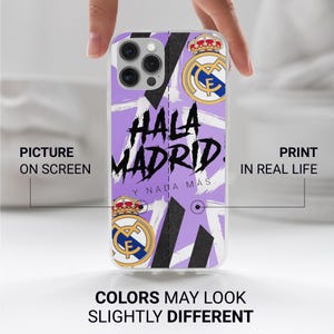 May include: A light purple phone case featuring the Real Madrid soccer club logo at the top and bottom, with black diagonal stripes and the text "HALA MADRID Y NADA M&Aacute;S" printed in a bold, black, brush-stroke style font across the center.