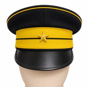 May include: A black military-style peaked cap featuring a wide yellow band around the center, accented by two thin black horizontal lines. A gold-colored five-pointed star is centered on the yellow band, and the cap has a black leather-like visor.