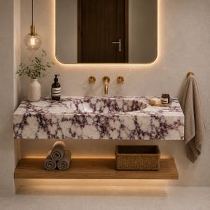 May include: A wall-mounted bathroom vanity featuring a white and deep purple marble countertop with an integrated oval sink, gold faucet fixtures, a wooden shelf below holding rolled towels and a woven basket, and a rectangular mirror above.