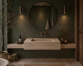 May include: A wall-mounted beige stone sink with a rectangular basin, positioned below a large circular mirror. The bathroom features dark olive green walls, two hanging pendant lights, a woven basket, a small potted plant, and a brown rug.