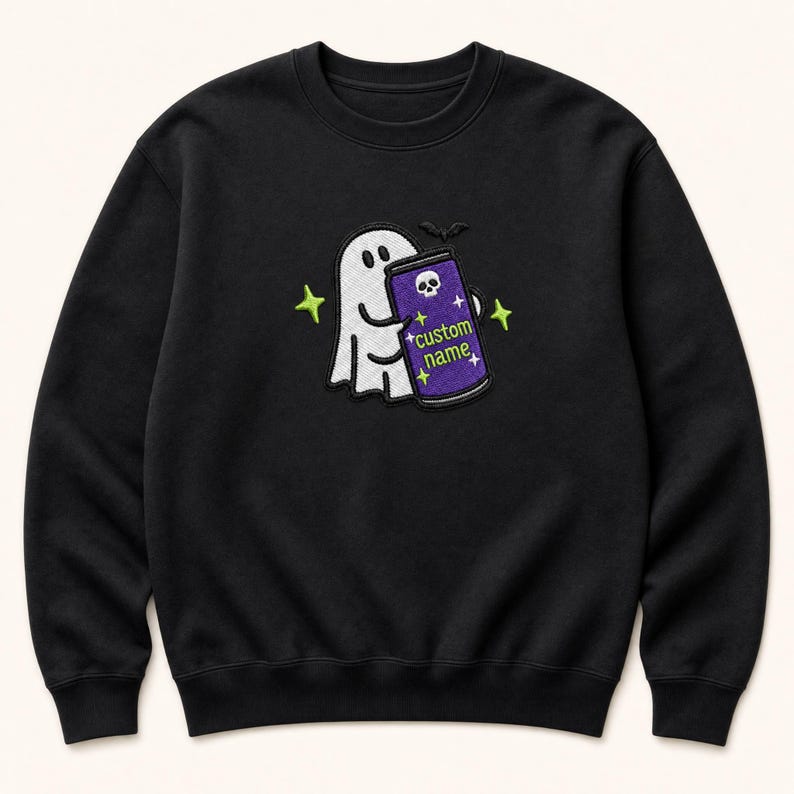May include: A black crewneck sweatshirt featuring an embroidered design of a white ghost holding a purple beverage can. The can displays a white skull icon, the text "custom name" in green, and small yellow stars. Bright green stars surround the ghost.