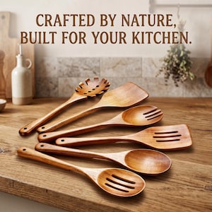May include: A set of six wooden kitchen utensils including a pasta server, a solid spatula, a fork, a slotted spatula, a solid spoon, and a slotted spoon. The text CRAFTED BY NATURE, BUILT FOR YOUR KITCHEN is displayed above the brown wooden tools.