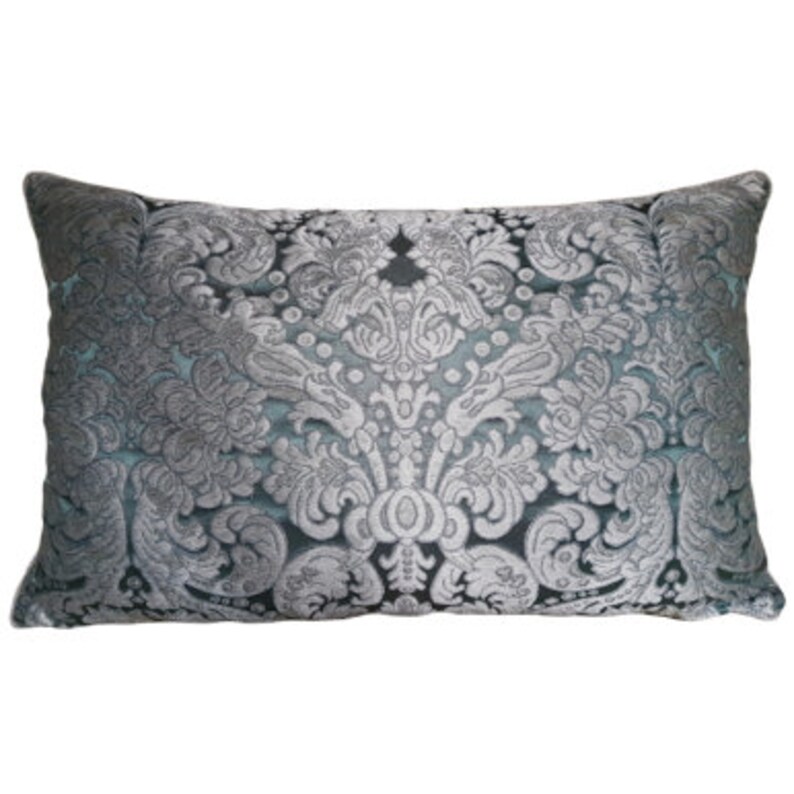 May include: A decorative throw pillow with a silver and blue damask pattern.