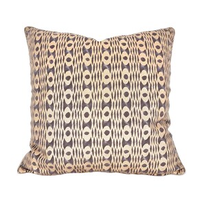 Op de afbeelding: Een decoratief kussen met een geometrisch patroon in beige en bruine tinten.