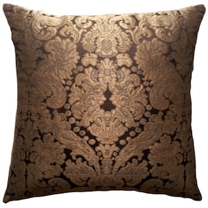 May include: A brown and gold decorative throw pillow with a damask pattern.