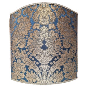 May include: A blue and gold patterned lampshade with a scalloped top edge.