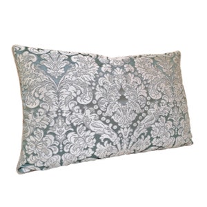 May include: A light blue cushion with a white damask pattern.