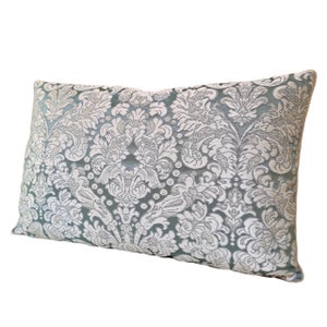 May include: A light blue cushion with a white damask pattern.