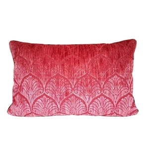 May include: A red velvet pillow with a white damask pattern. The pillow has a black trim.