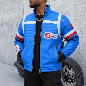 May include: A bright blue jacket with a stand-up collar, featuring quilted shoulder panels, white and red stripes on the sleeves, and a circular patch on the chest with a graphic of a winged horse and the text Dead Pegasus in black lettering.