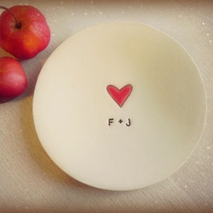 May include: White ceramic dish with a red heart and the initials "F + J" in black.
