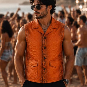 May include: A sleeveless orange vest with a textured snakeskin pattern, featuring a collared neckline, a front button closure with four dark buttons, and two front flap pockets. The vest is worn over black trousers and paired with dark sunglasses.
