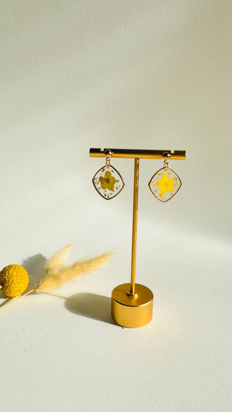 Dainty yellow pressed flower resin earrings in gold diamond frames