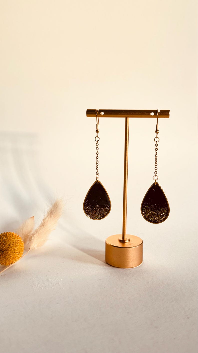 Black and gold glitter teardrop earrings on long gold chains