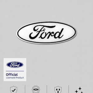 May include: An oval Ford emblem decal featuring the black script logo on a white background with a silver border. The graphic includes text stating Official Licensed Product, Overlays over original Ford keeps chrome visible, Durable & Weather Resistant, and Gloss Finish.